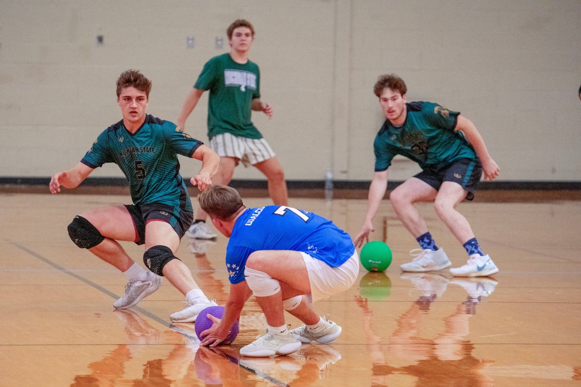 Two teams of dodgeball players competing in a match.